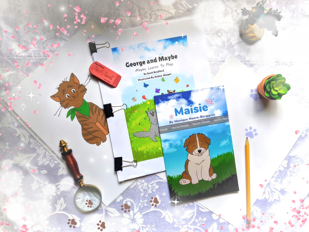 Artist table with animals, pawprints, and random doodads showing book in progress.